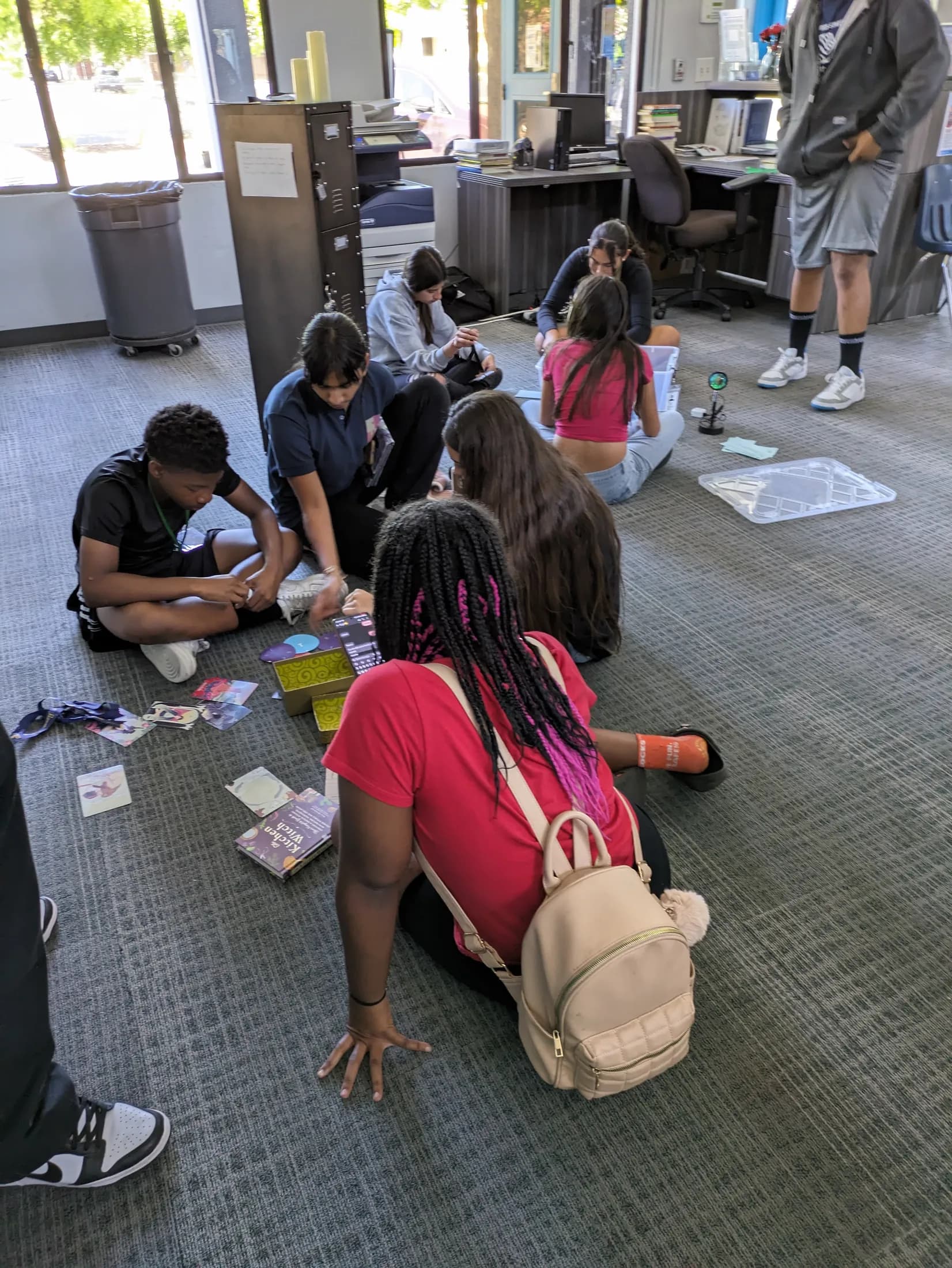 Players sitting on the floor working through clue cards